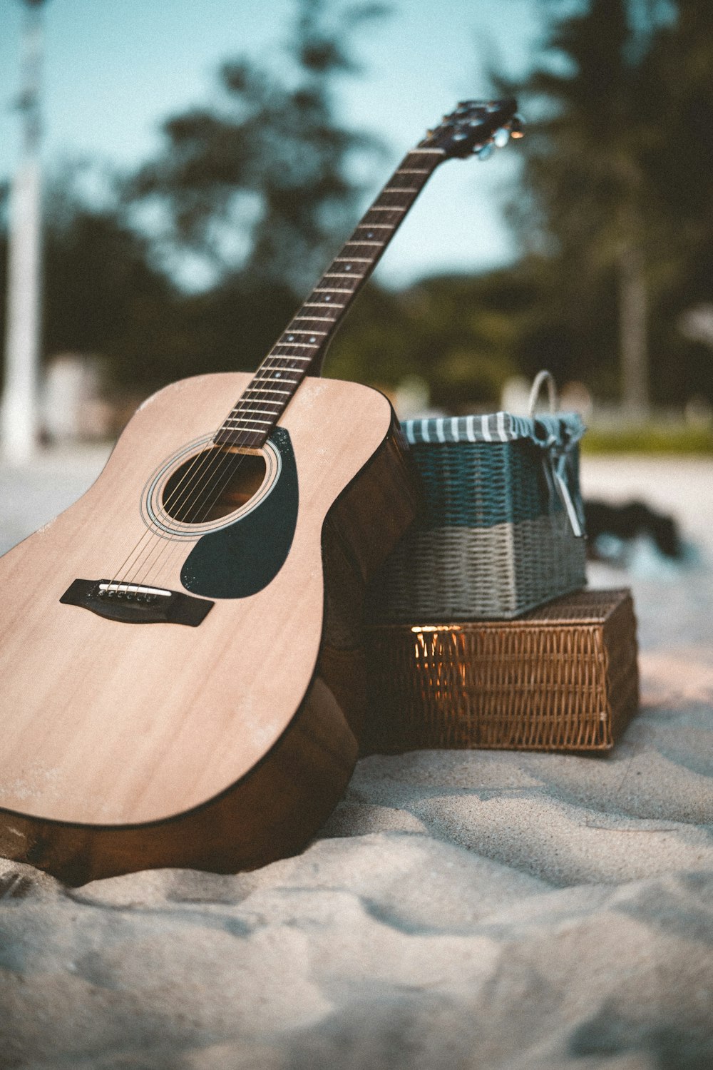 brown acoustic guitar on brown wooden table