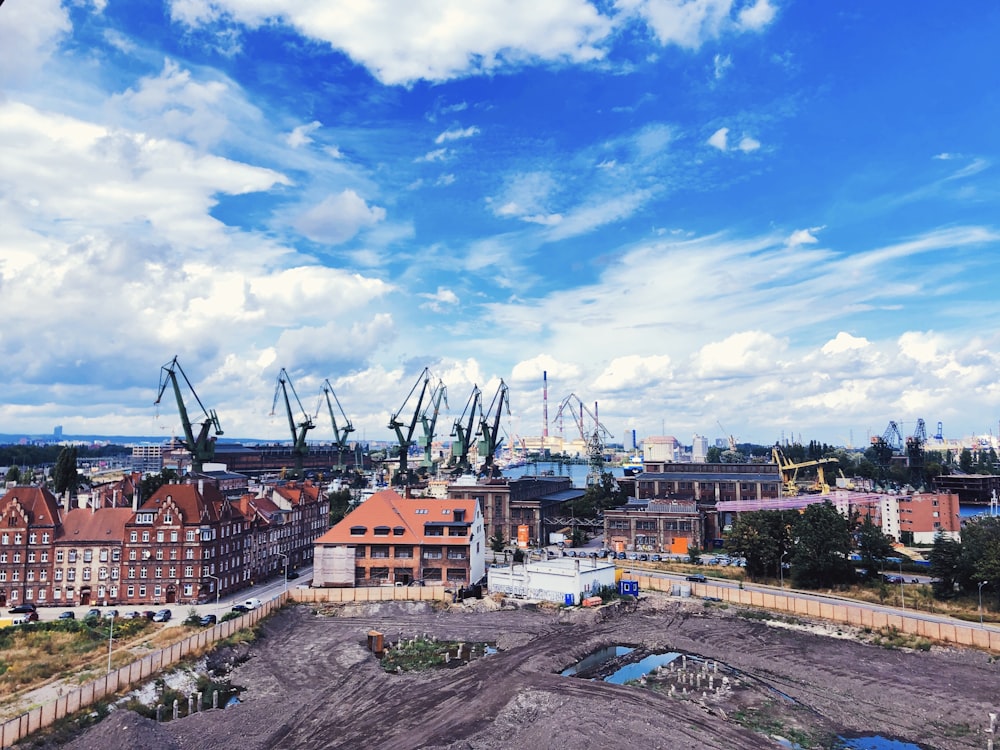 houses and buildings under blue sky and white clouds during daytime