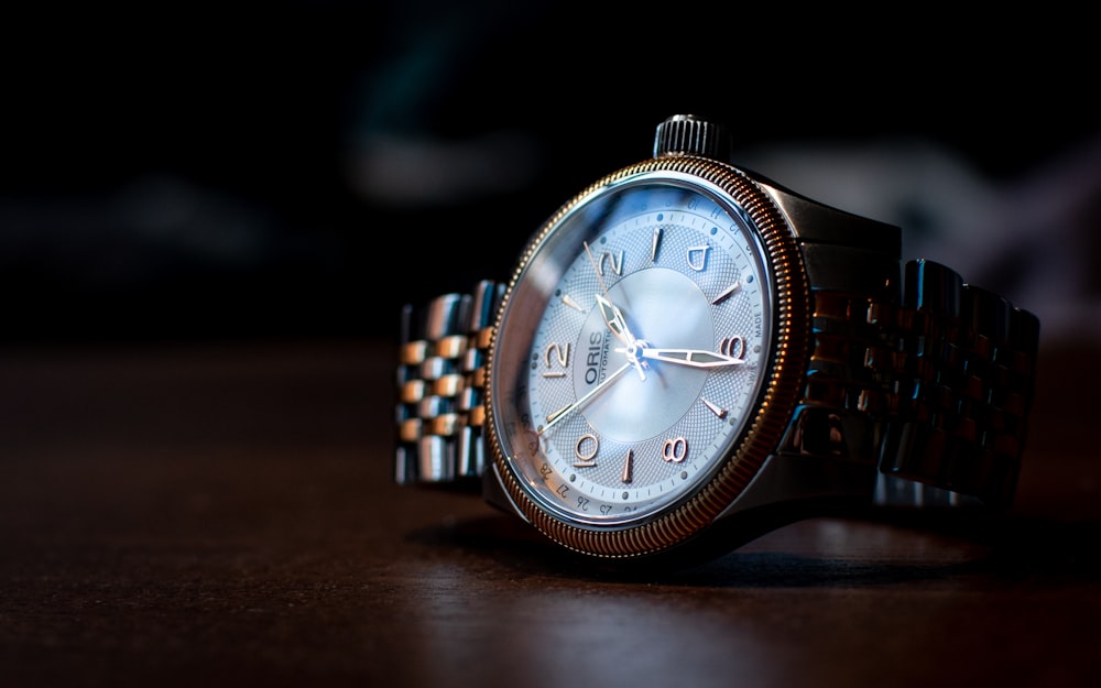 silver and blue analog watch at 10 10