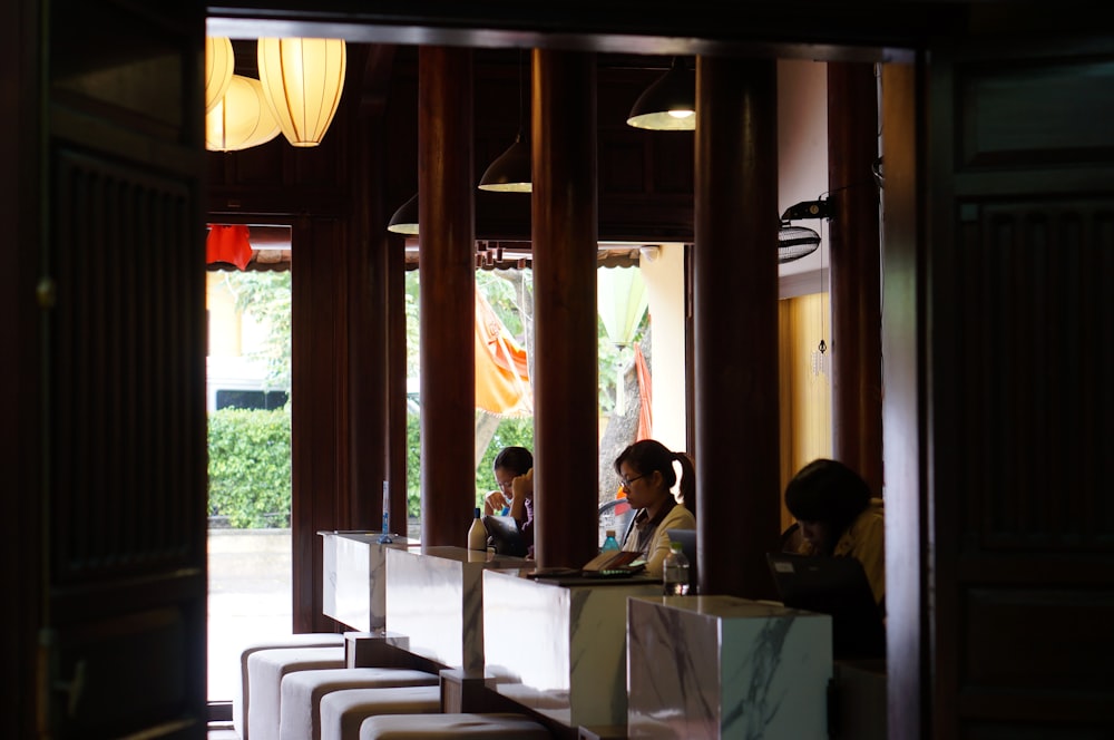 people sitting on chair near table during daytime