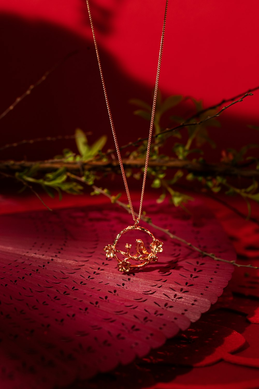 silver diamond studded ring on red leaf