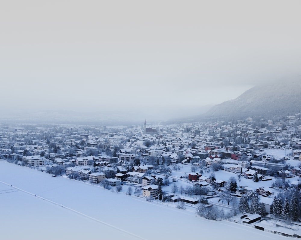 white and black houses on snow covered mountain during daytime