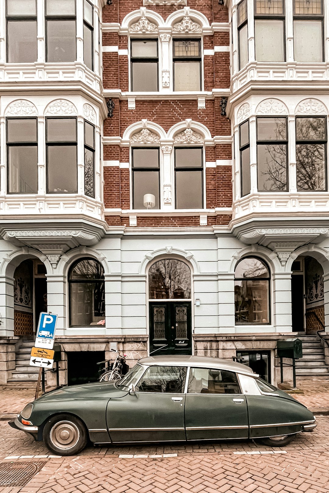 cars parked in front of brown building