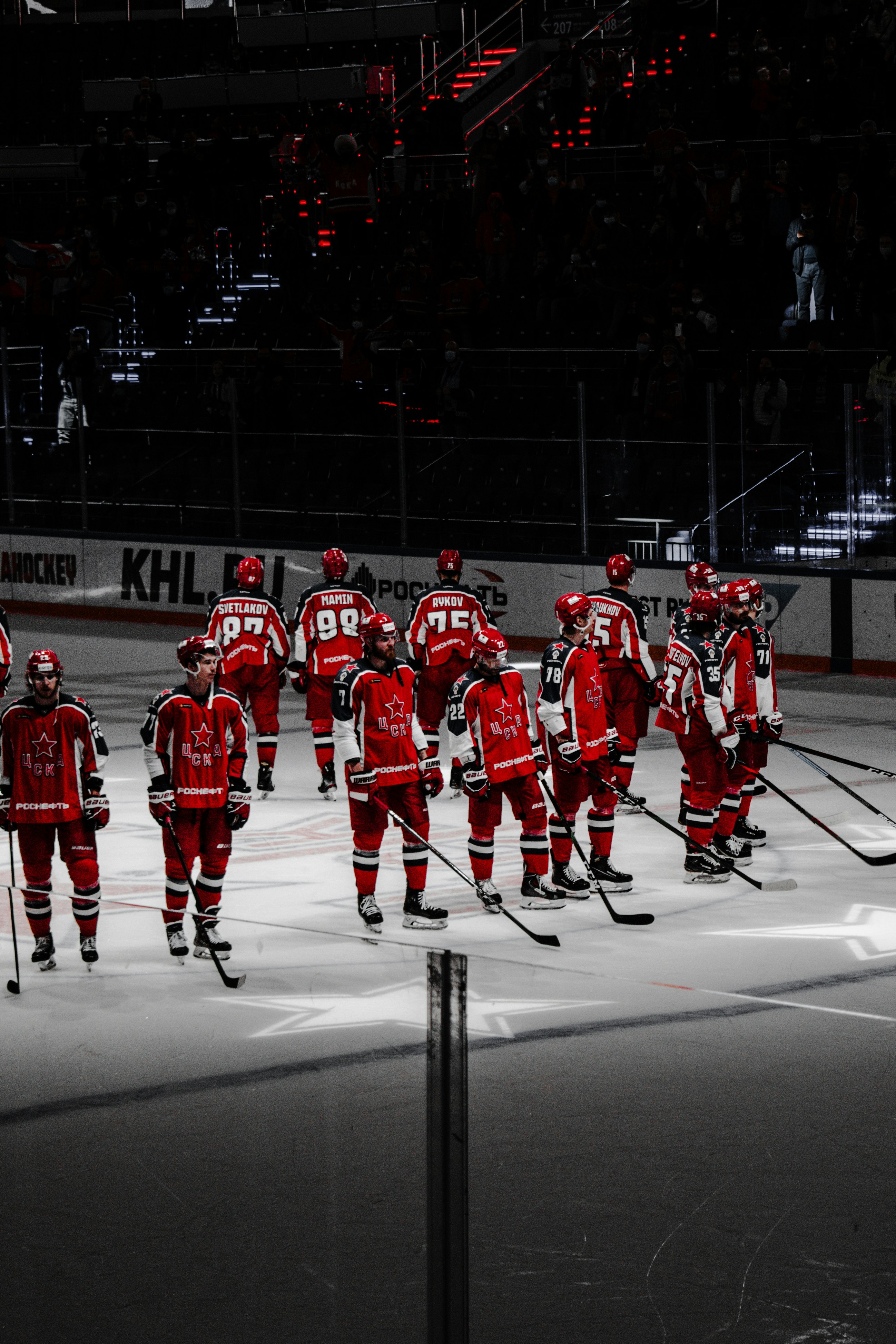 Hockey players in red and white sweaters, showing how uniform design carries a club's visual identity across a league