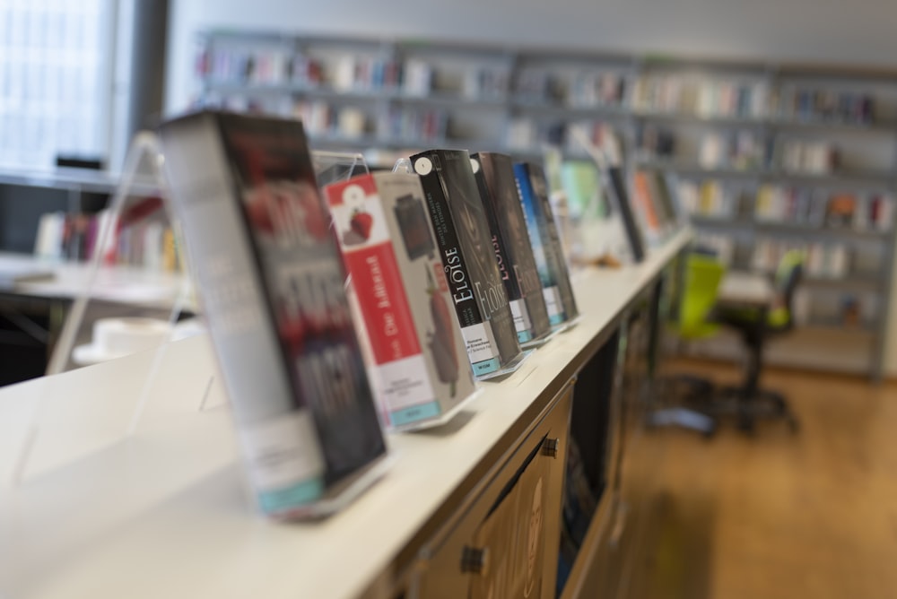 assorted books on white wooden shelf