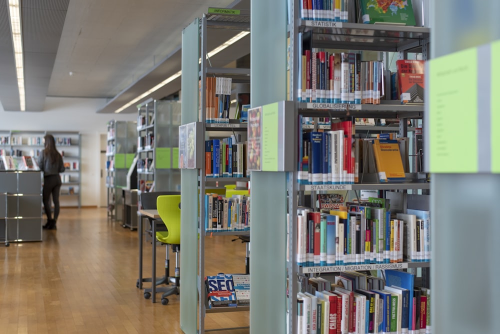 green and brown wooden book shelves