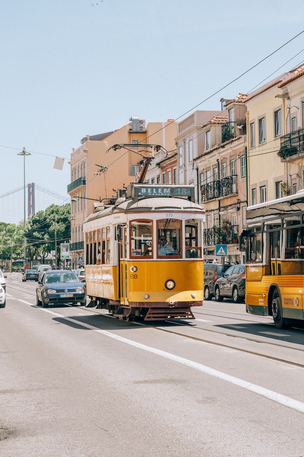 yellow tram on road during daytime