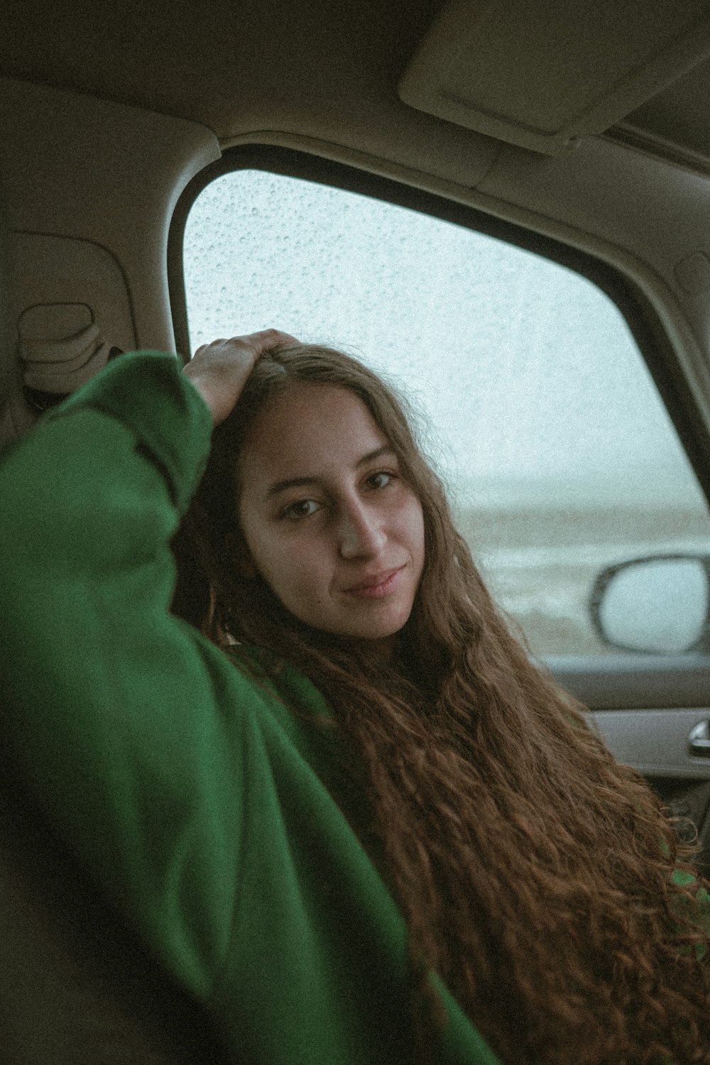 woman in green hoodie inside car