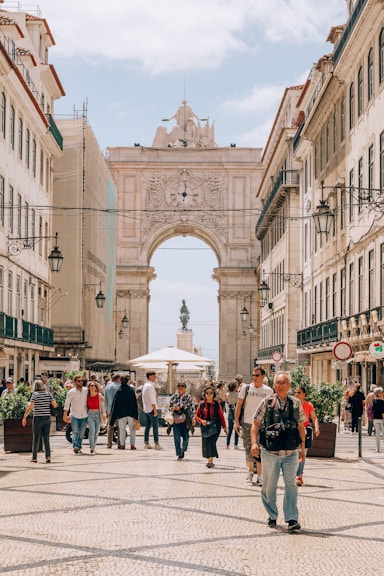 people walking on street near white concrete building during daytime