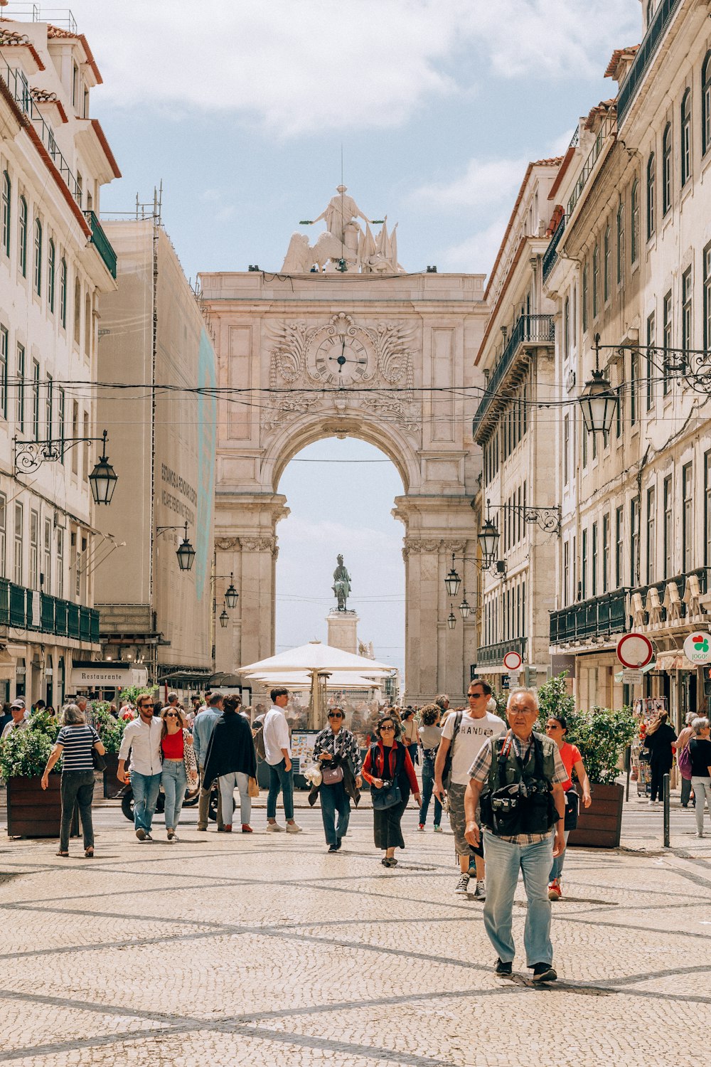 people walking on street near white concrete building during daytime