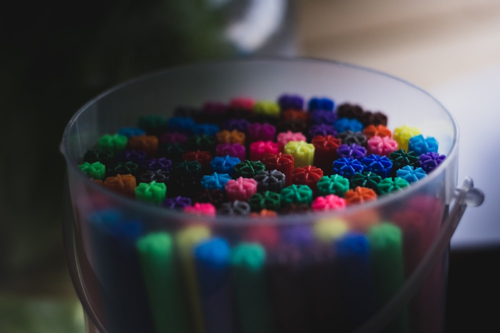 assorted color beads in clear glass bowl