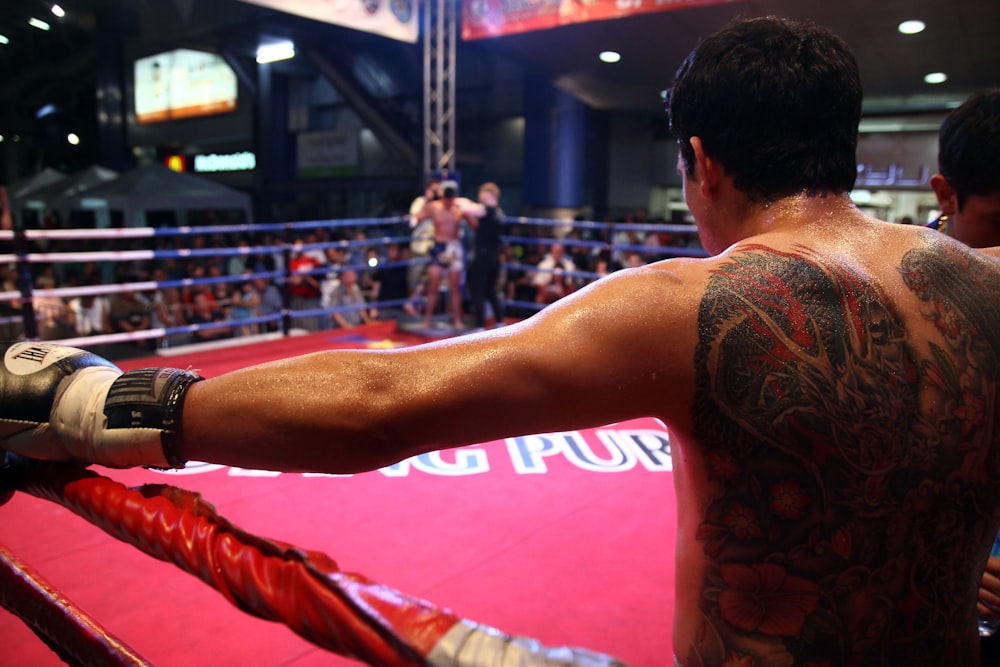 man in red tank top with tattoo on his back