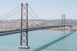 red bridge over body of water during daytime
