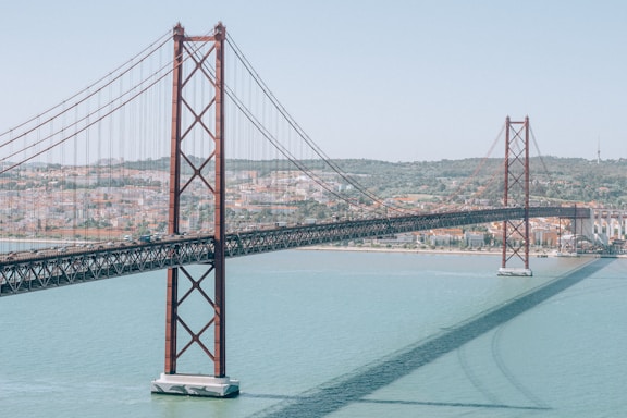 red bridge over body of water during daytime