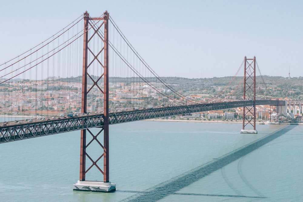 red bridge over body of water during daytime