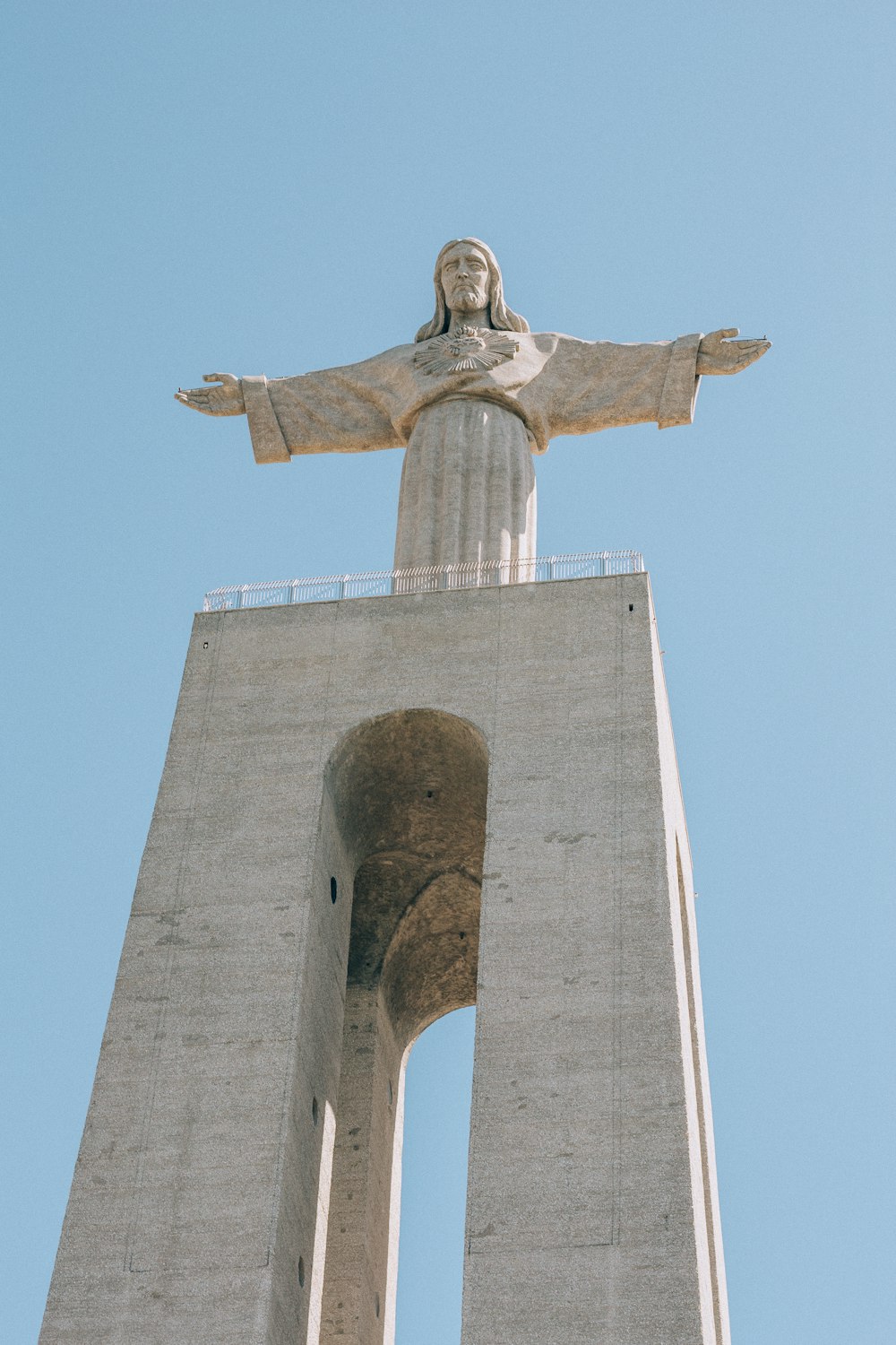 gray concrete cross under blue sky during daytime