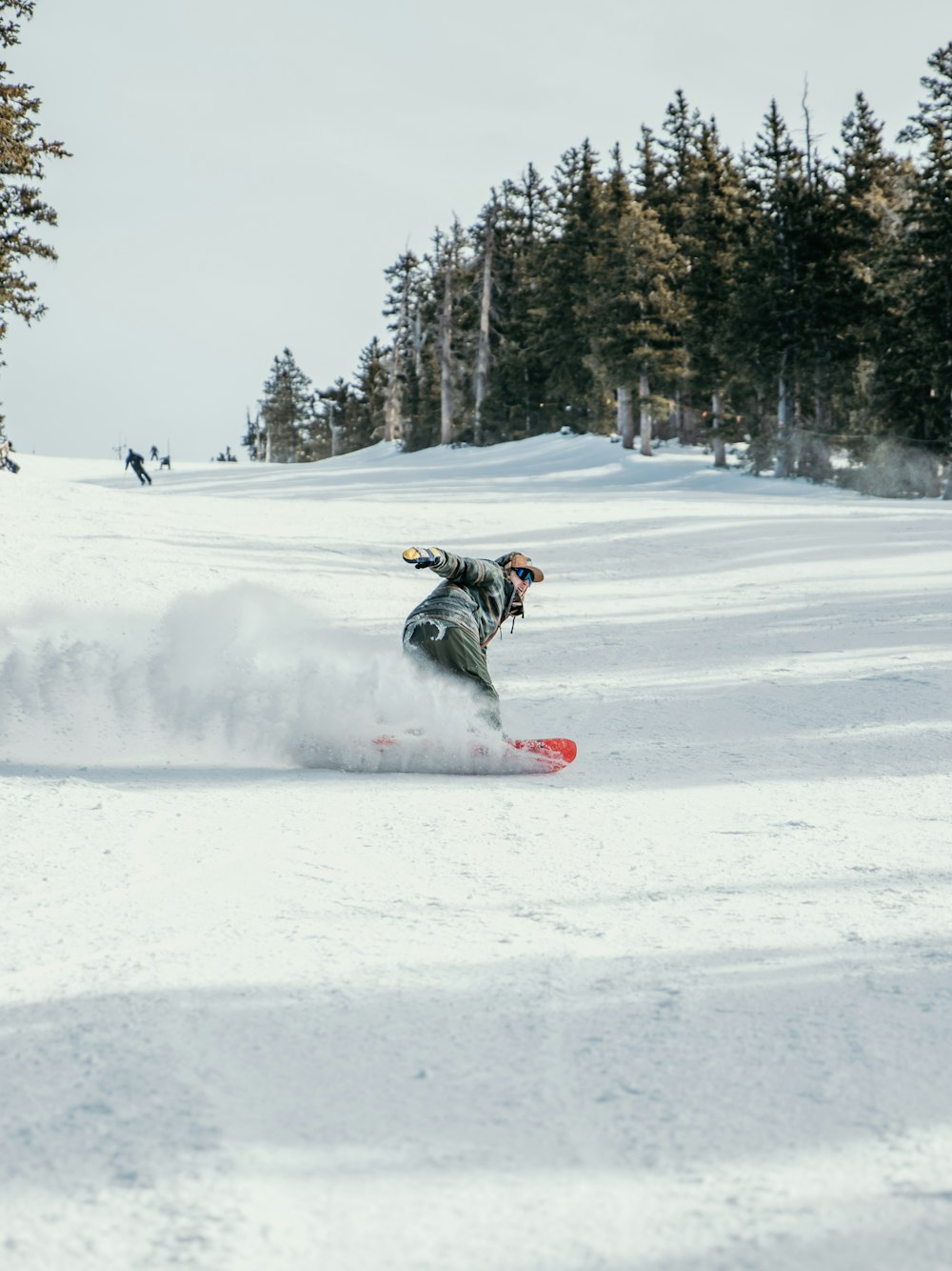 person in black jacket riding on snowboard during daytime