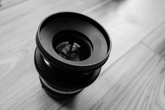 A close-up of a camera lens focused on a stylish kitchen countertop.