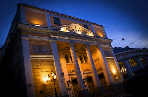 Institutional building lit up at dusk, showcasing electrical work.
