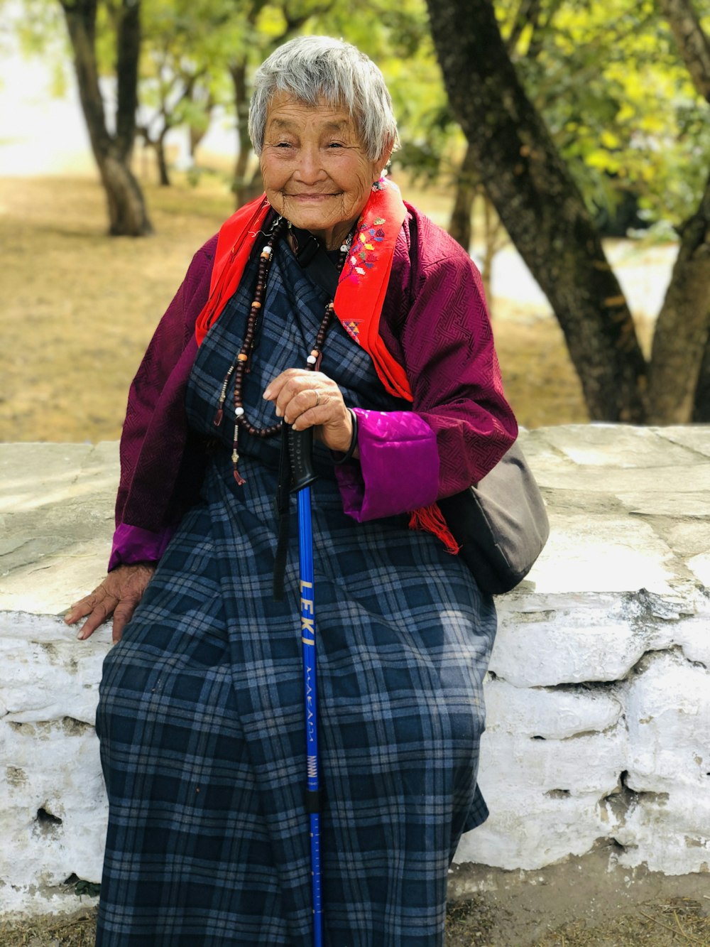 woman in red cardigan and blue and black plaid skirt