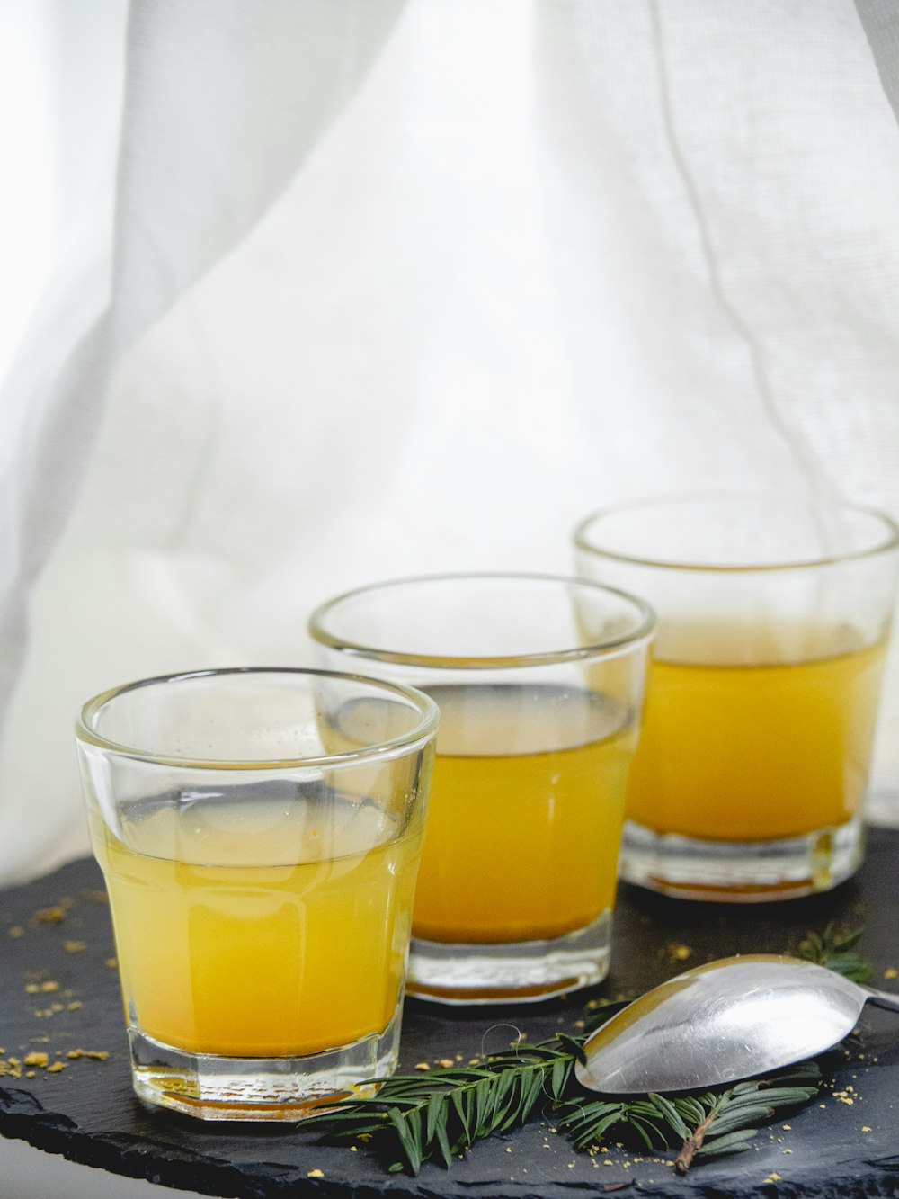 clear drinking glass with yellow liquid