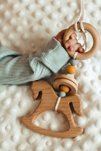 A toddler happily grasping a safe, textured teething ring.