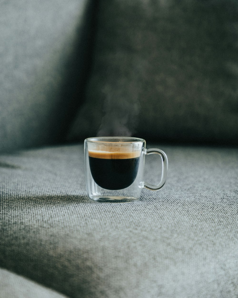 clear glass mug with brown liquid