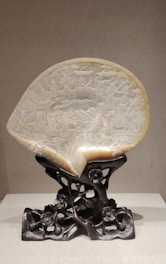 Close-up of intricately carved coconut shell crafts showcasing fine details.