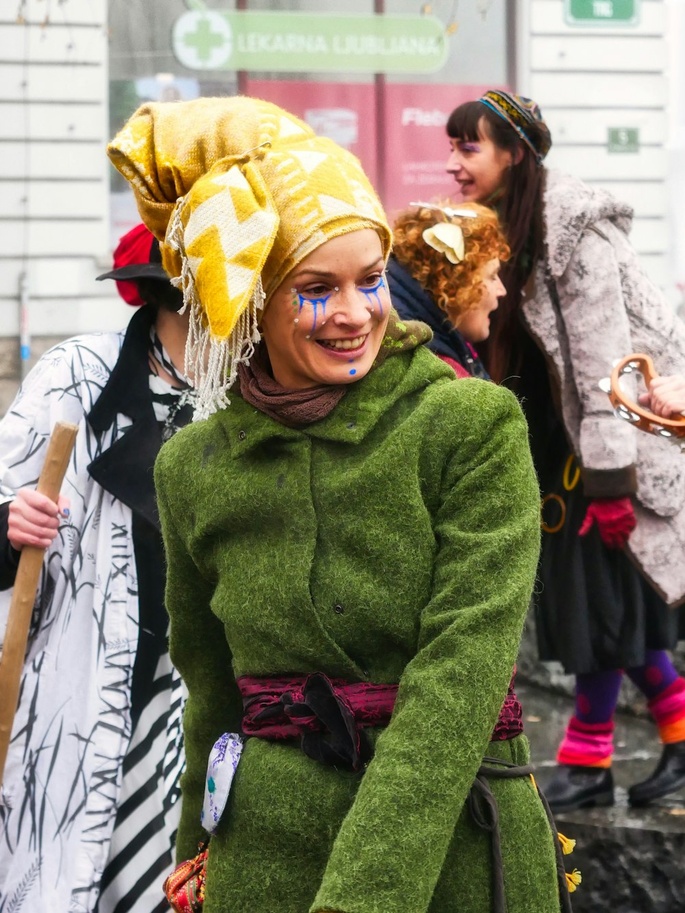 woman in green sweater and yellow hat