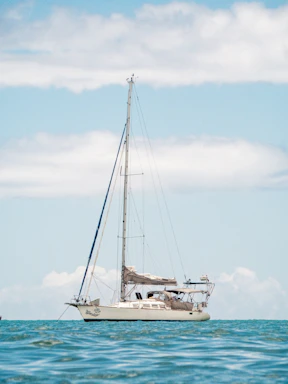 white sail boat on sea during daytime