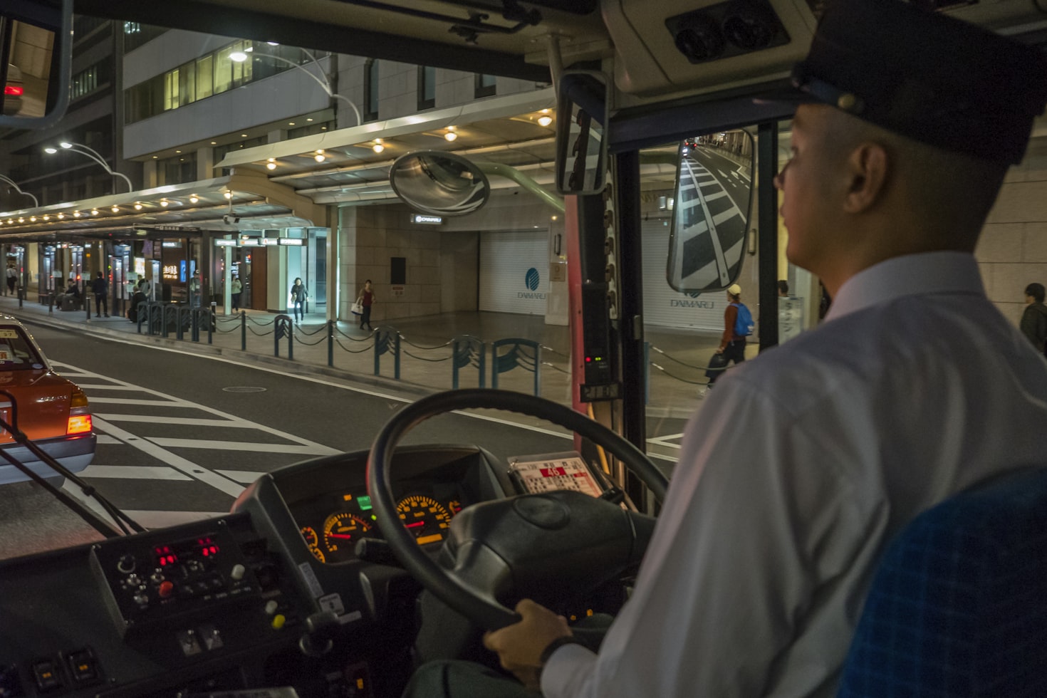 Bus driver greeting passengers with a warm smile