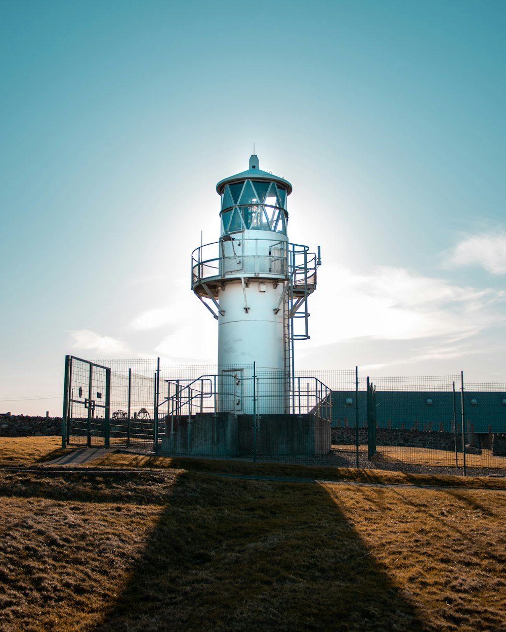 white and black lighthouse under gray sky