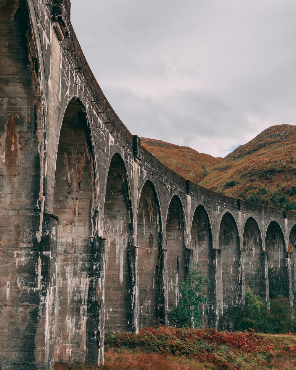 gray concrete bridge under white sky during daytime