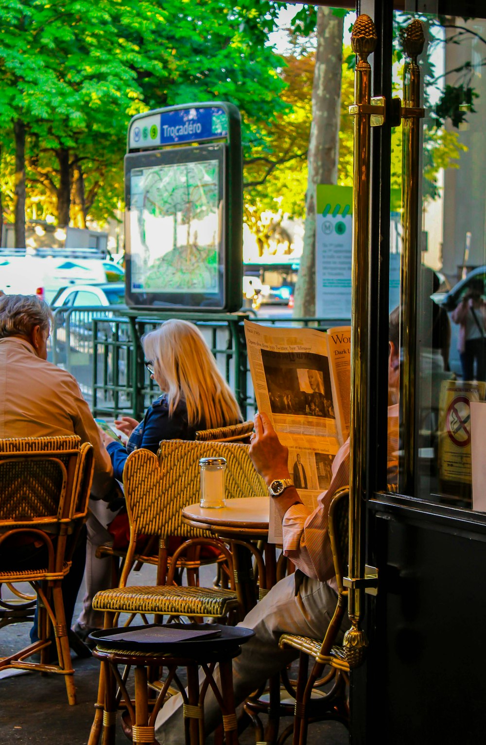 people sitting on brown wooden chairs