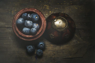 Freshly harvested açaí berries laid out on rustic wooden table.