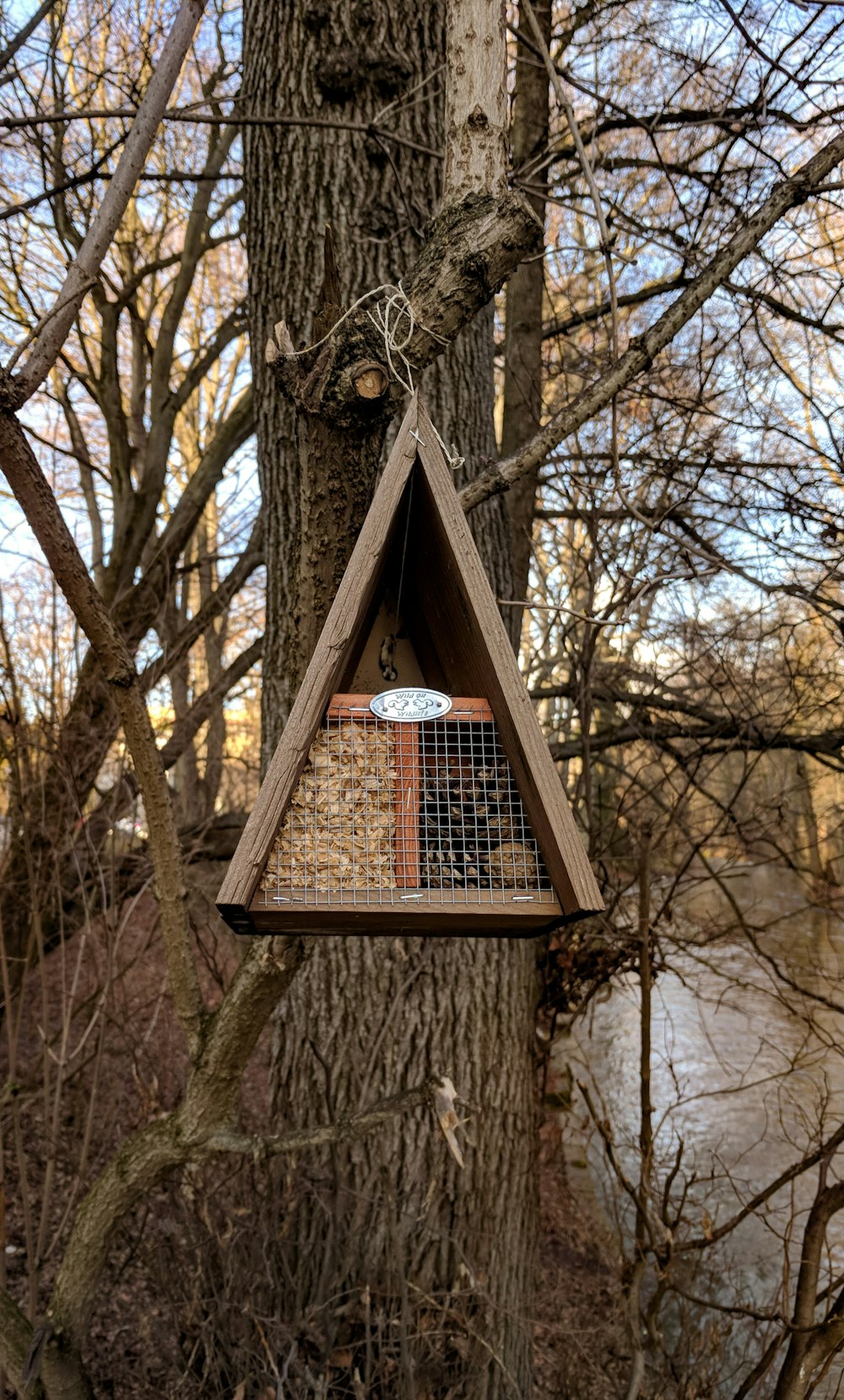 brown wooden birdhouse on brown tree