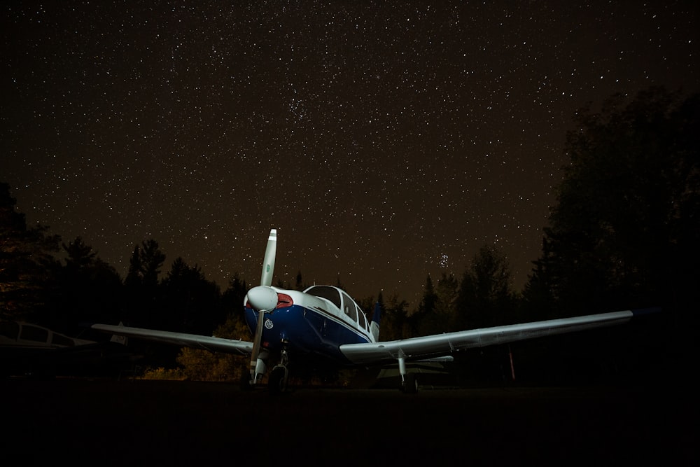 white airplane on the ground during night time