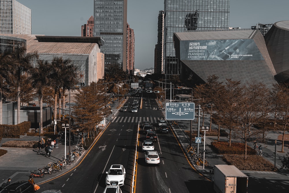 cars on road near high rise buildings during daytime