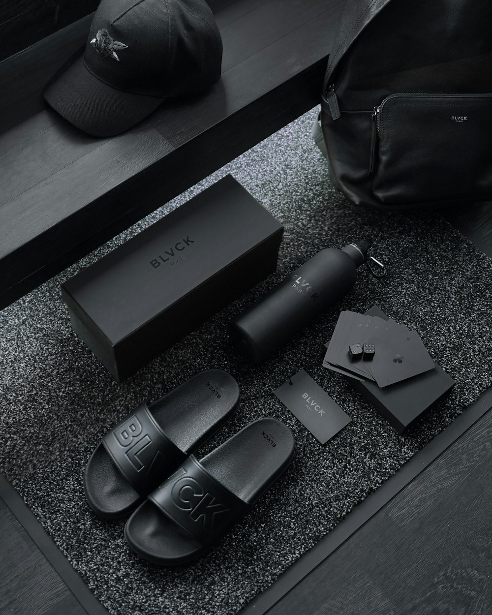 black sony remote control beside black leather bag