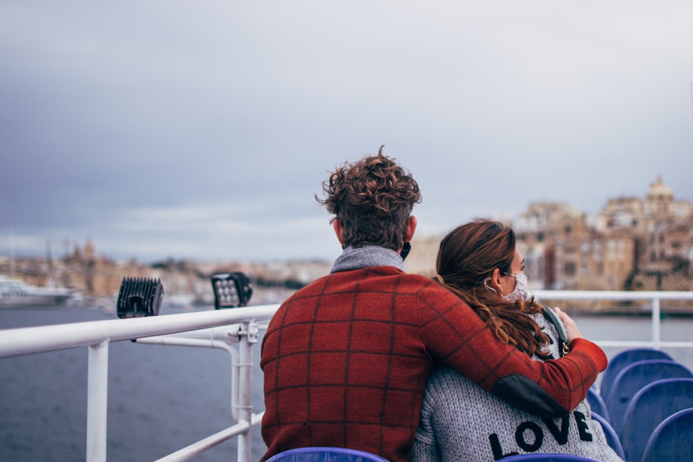 couple standing on white ship during daytime