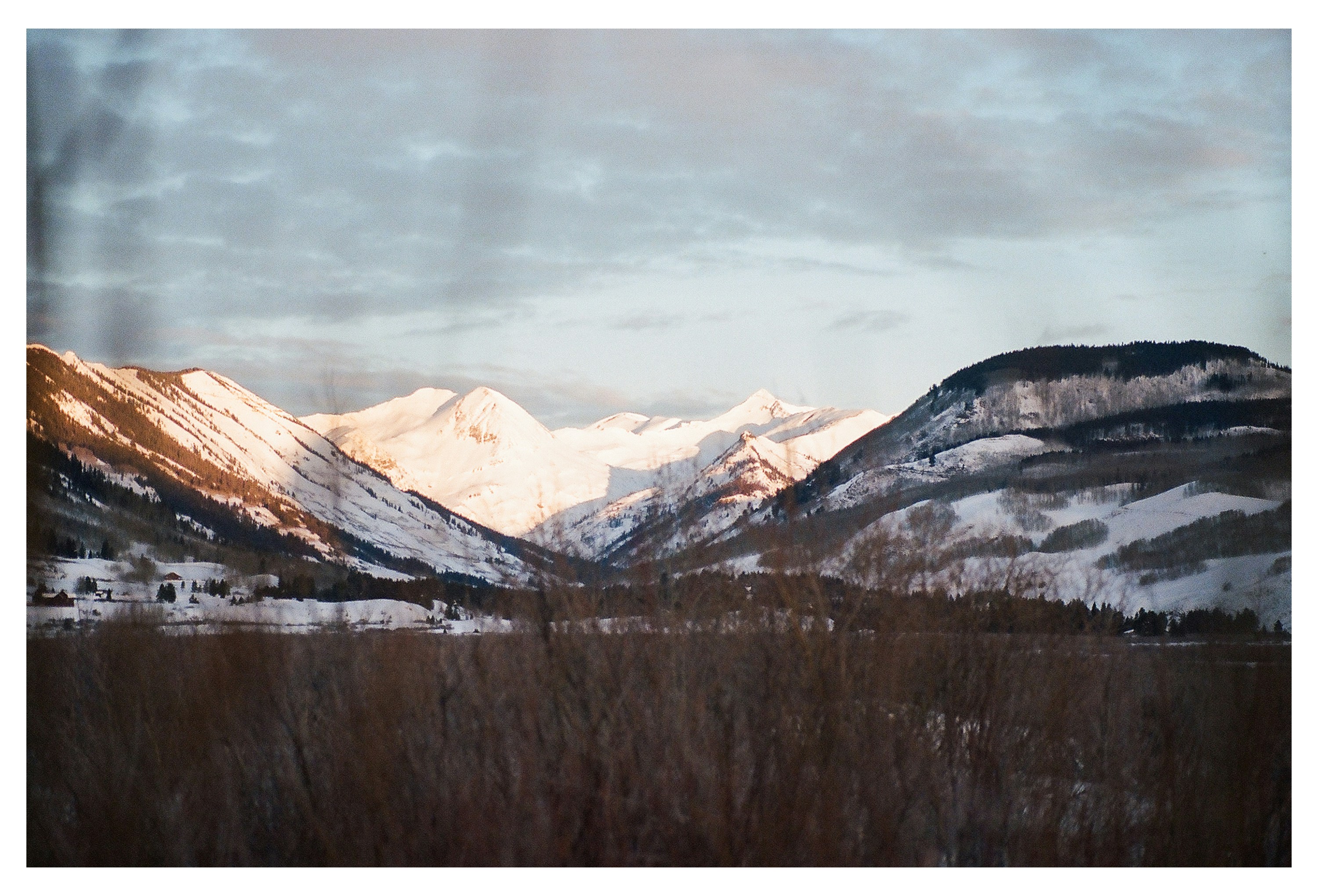 brown and white mountains under white clouds during daytime