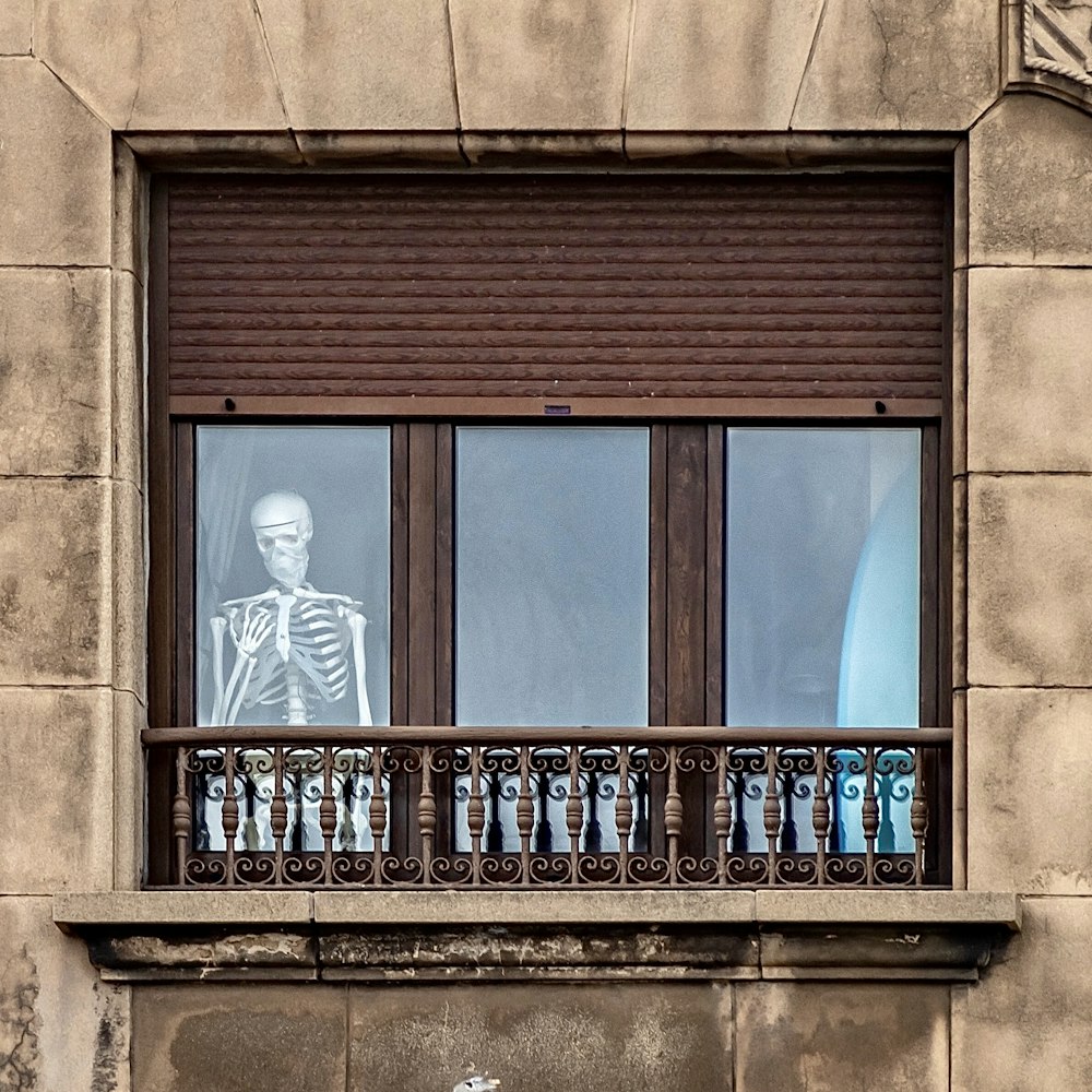 brown concrete building with blue window