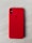 A smartphone with a red protective case resting on a light wooden surface. The case features a brand logo subtly embossed in the center. The camera lenses are visible on the top left corner of the case.
