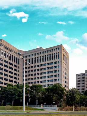 An aerial view of a modern office building surrounded by greenery.