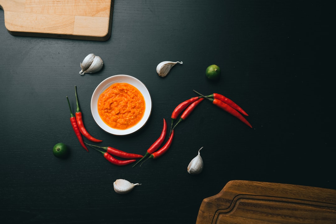 red chili on brown wooden chopping board