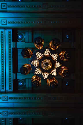 Close-up of an intricate ceiling design featuring wood paneling and recessed lighting.