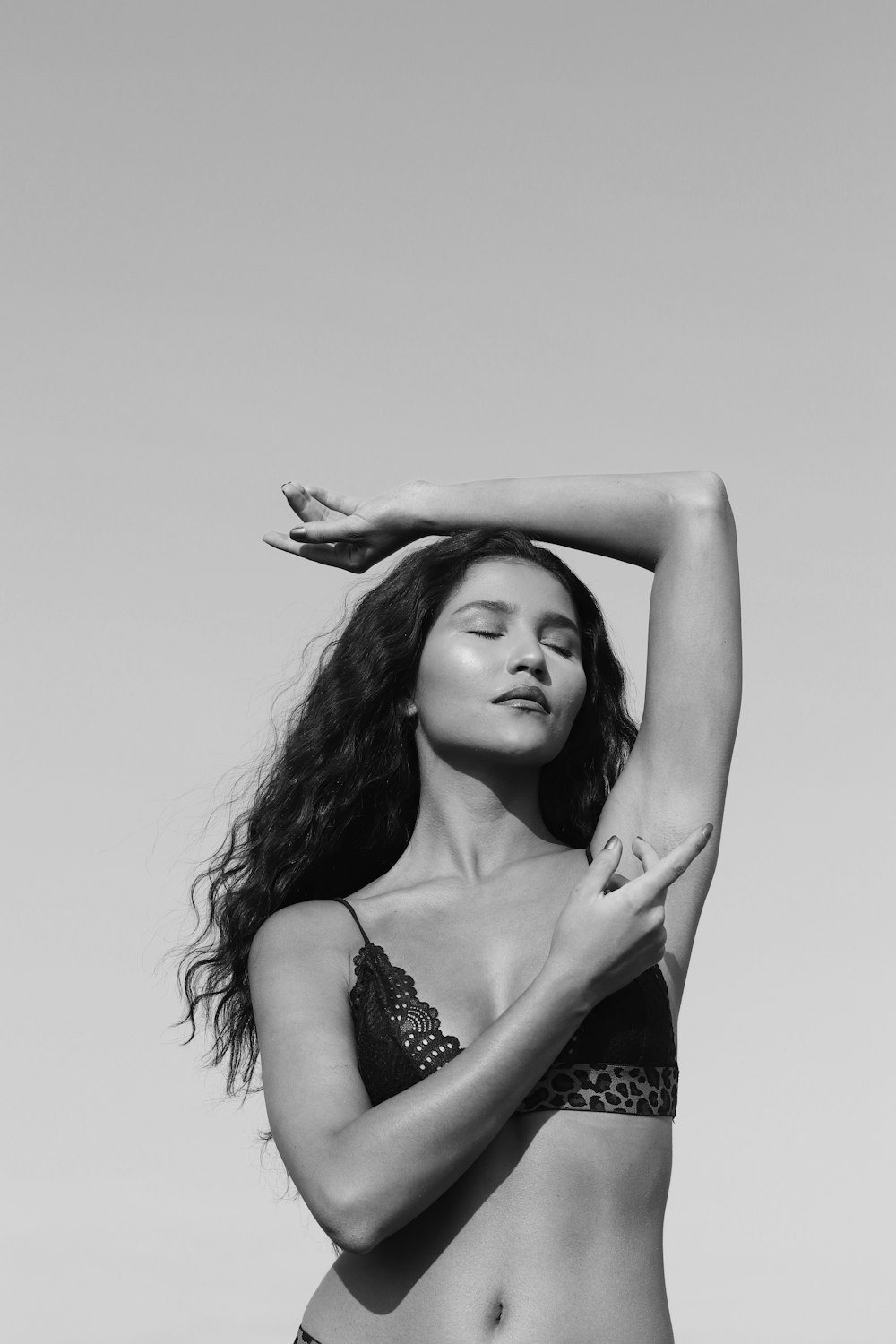 grayscale photo of woman in spaghetti strap dress