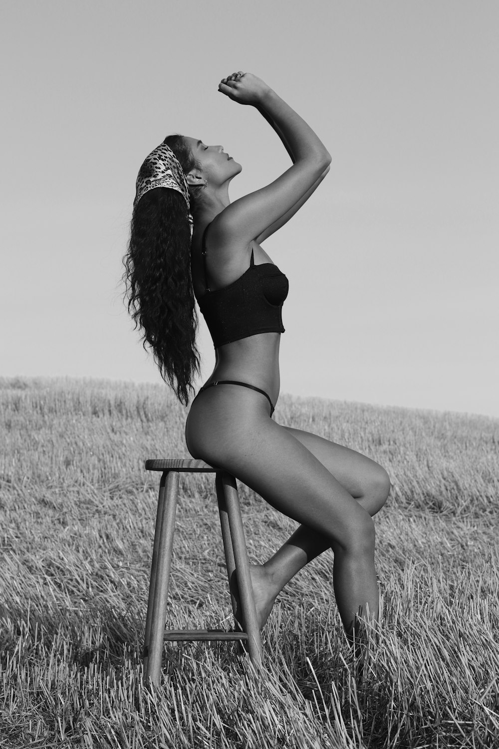 woman in black bikini sitting on chair