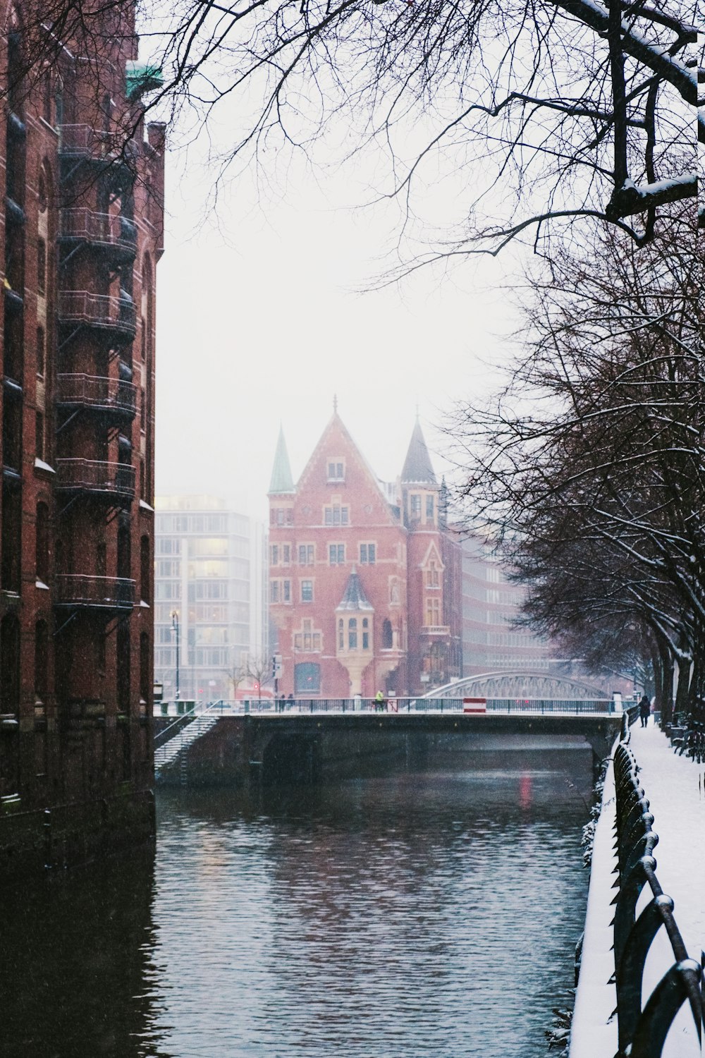 brown concrete building beside river during daytime