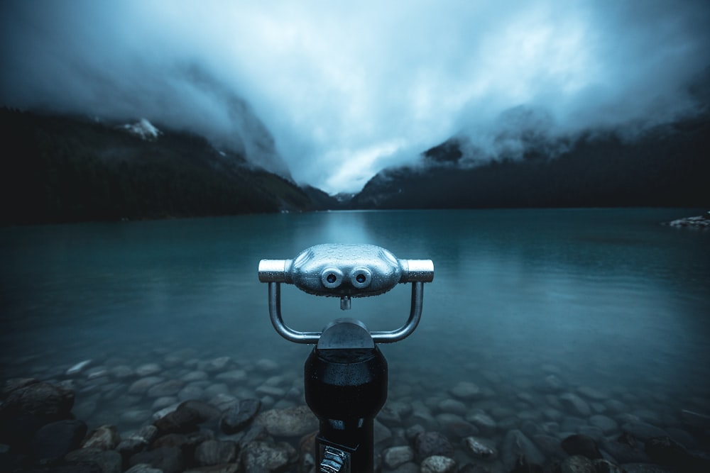 black binoculars on body of water